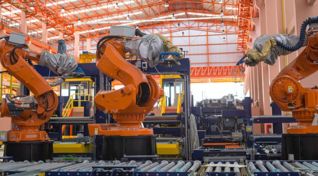 Robots welding in a production line