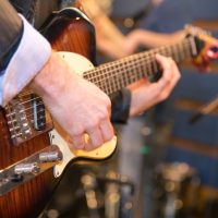 Music band guitarlist playing in studio