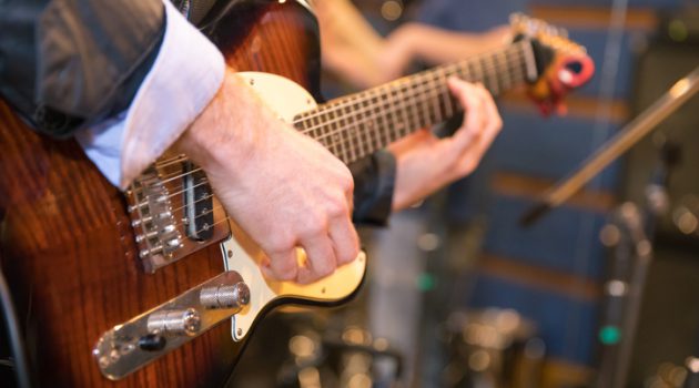 Music band guitarlist playing in studio